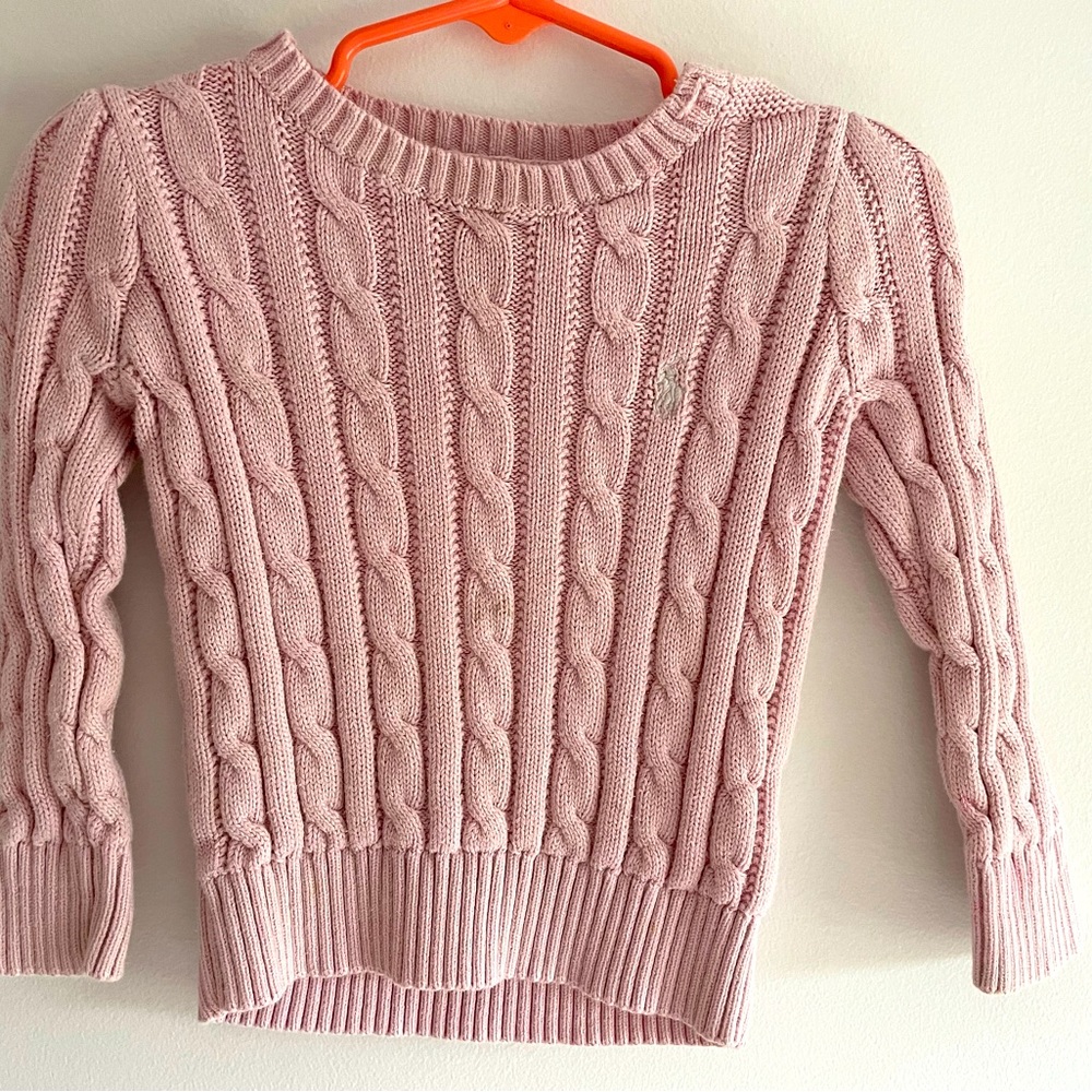 Pink sweater. Good condition. It has a small blue stain.